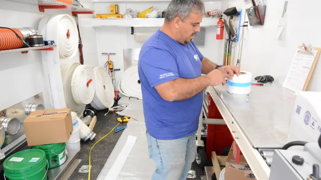 Technician measuring a liner at the workbench inside the truck